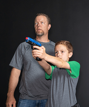 Father and son learning to virtually shoot